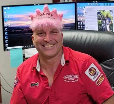 Eric Guillory smiling in his former business office